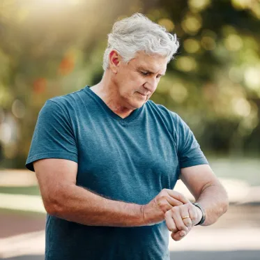Older man looking at his smartwatch.